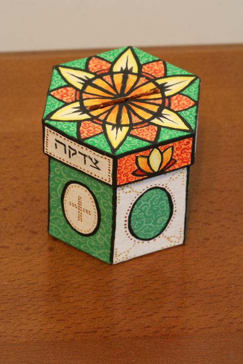 A painted cardboard coin bank for charity savings.  $20