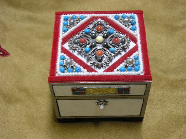 A smaller hinged box, painted and decorated regally with both faux and genuine gemstones.  $55